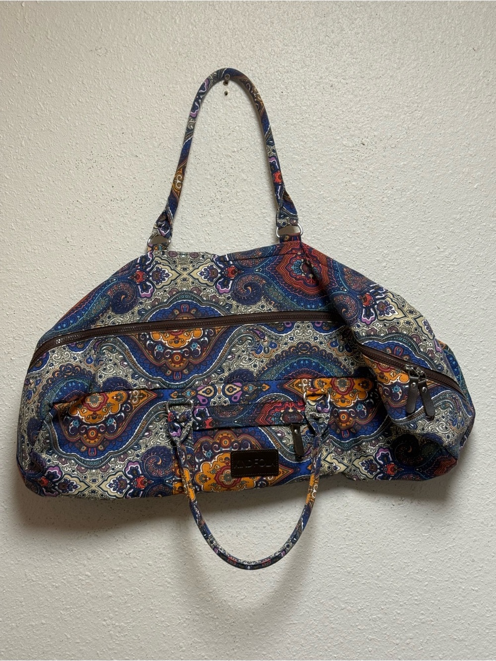 KindFolk Yoga Mat Duffle Bag in a colorful blue-and-orange paisley pattern.